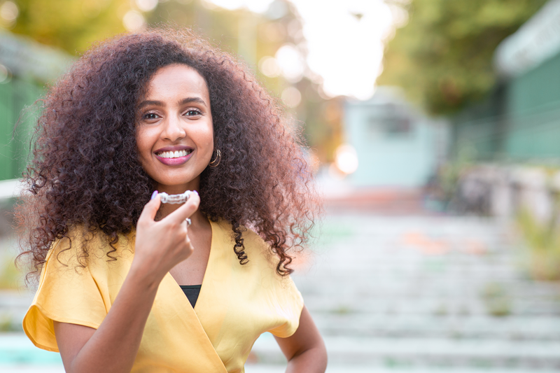 Woman holding a dental appliance